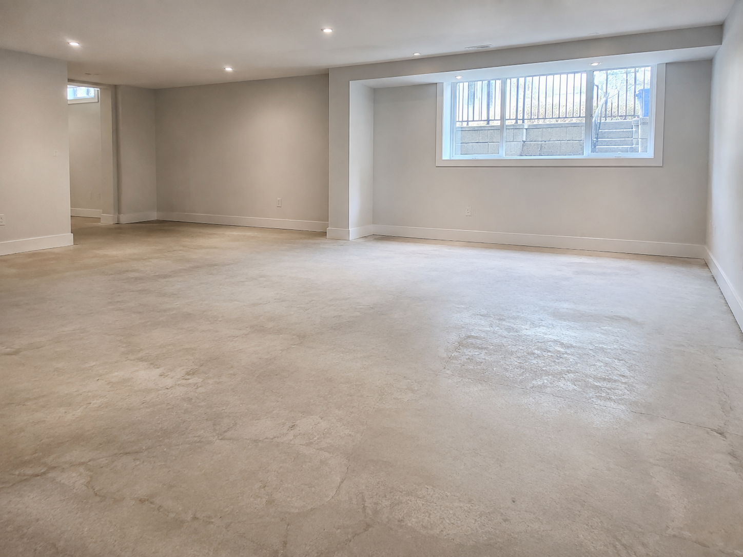 Bare concrete basement floor before epoxy
